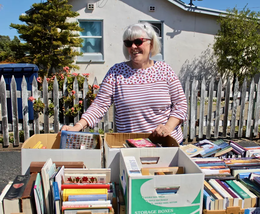 Librarian Darlene preparing books for sell.