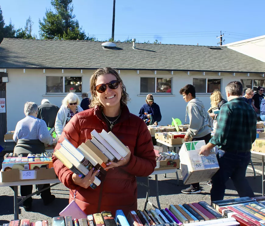 A happy customer at a Grover Beach Community Library book sale.
