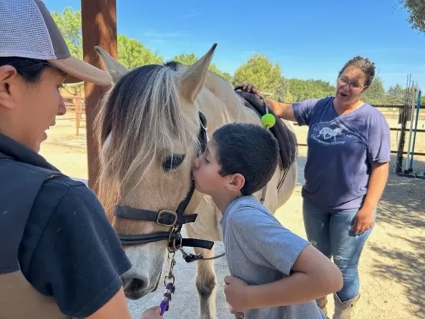 Logan with his equine partner Mari