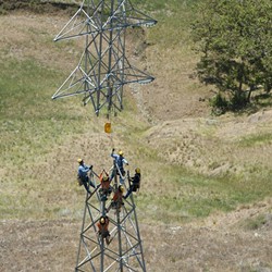 OUT OF POWER PG&amp;E crews work on a power line tower in SLO County. SLO County could be hit with rotating power outages in the coming days. - FILE PHOTO BY STEVE E. MILLER