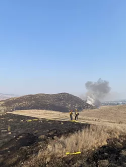 Crews prevent open space fire from reaching SLO homes