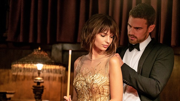KINDRED SPIRITS Elyse (Emily Ratajkowski) meets Ivan (Theo James) at a party, where he's there to steal artwork and she's working a con, and they develop an uneasy pact, in the crime drama Lying and Stealing, available on HBO and Amazon Prime. - PHOTO COURTESY OF 50 DEGREES ENTERTAINMENT