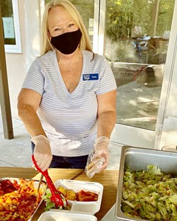 CHIPPING IN El Camino Homeless Organization (ECHO) volunteer Wendy Johnson serves dinner to clients in Atascadero on Jan. 7. ECHO is looking for more community volunteers to help with its expansion to Paso Robles. - PHOTO COURTESY OF WENDY LEWIS