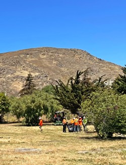 CLEANING UP Crews finish a cleanup of a homeless encampment off the interchange of Highway 101 and Madonna Road in SLO on June 10. - PHOTO BY PETER JOHNSON