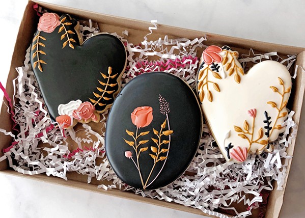 SWEETHEART Alexa Smith freehand designs many of her treats. A fellow baker provided the inspiration for her heart-shaped sugar cookies, then she fine-tuned the coloring and floral placement. - PHOTO COURTESY OF NIGHT SHIFT COOKIE CO.