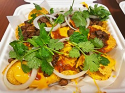 GOURMET GRUB Spicy queso, ranchero beans, and fresh herbs top Gold Land BBQ's tri-tip nachos. Rotating specialties will be featured at SLO's Thursday night farmers' market. - PHOTOS BY CHERISH WHYTE