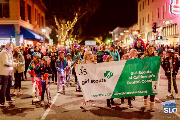 TAKE TO THE STREETS About 80 local groups are signed up to participate in this year's SLO Holiday Parade. In the 2019 event, the Girl Scouts of California's Central Coast were among them (pictured). - PHOTO COURTESY OF STEPHEN HERALDO FOR DOWNTOWN SLO