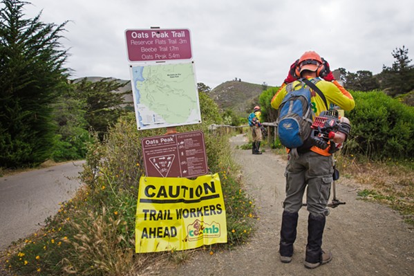 CAUTION A temporary sign warns trail users at Monta&ntilde;a de Oro that volunteers are hard at work. - PHOTO BY JAYSON MELLOM