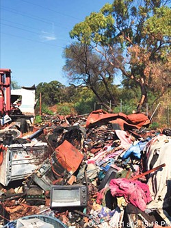 LOTS OF STUFF The city of San Luis Obispo is suing a local landowner over the condition of his property next door to the 40 Prado Homeless Center. Accumulated materials and items are scattered throughout the 2.2 acres. - IMAGE COURTESY OF THE CITY OF SLO