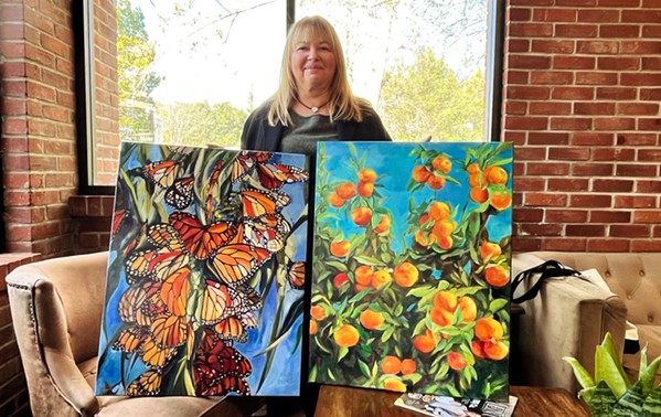 VIBRANT RESILANCE Irene displays her pieces (oil on linen) For Ukraine (right) and Freedom (left) which represent the resilience of her home country in the face of their current crisis combined with the beautiful nature found across SLO county. - PHOTOS BY ADRIAN ROSAS