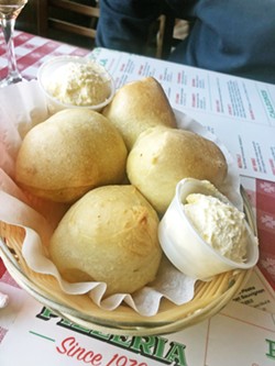 SOUTH COUNTY STAPLE Del's famous bread rolls are made fresh daily with pizza dough and come with easy-to-spread whipped honey butter. - PHOTO BY BULBUL RAJAGOPAL