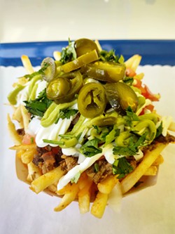 PEEL DEAL The asada fries at French Fries in Arroyo Grande is one of six signature fry combinations. Patrons of the new eatery can also build their own fry assortments from scratch with dozens of topping options to choose from. - PHOTO BY CALEB WISEBLOOD