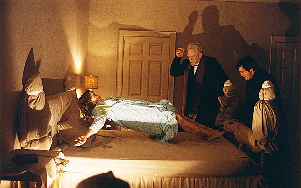 CUE THE PEA SOUP Regan (Linda Blair) undergoes an exorcism by Catholic priests Father Merrin (Max von Sydow) and Father Karras (Jason Miller), in the 1973 horror classic, The Exorcist, screening at the Palm Theatre on Oct. 21. - PHOTO COURTESY OF WARNER BRO.