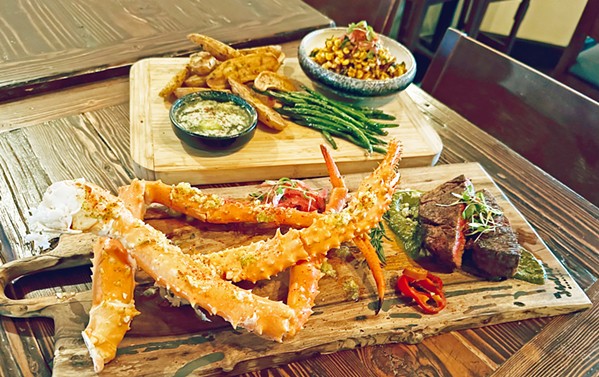 CELEBRATING LAND AND SEA Feast on poached king crab legs with salsa verde butter, filet mignon atop charred scallion chimichurri, roasted corn and edamame succotash, and more at La Cosecha in Paso Robles on New Year's Eve. - PHOTO COURTESY OF LA COSECHA BAR + RESTAURANT