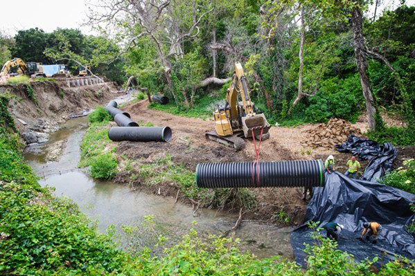 CREEK CURE In the aftermath of the record rainstorms in 2023, the city of SLO tried to reinforce the SLO Creek bank by diverting the creek's full flow of water through a narrow pipe. - FILE PHOTO BY JAYSON MELLOM