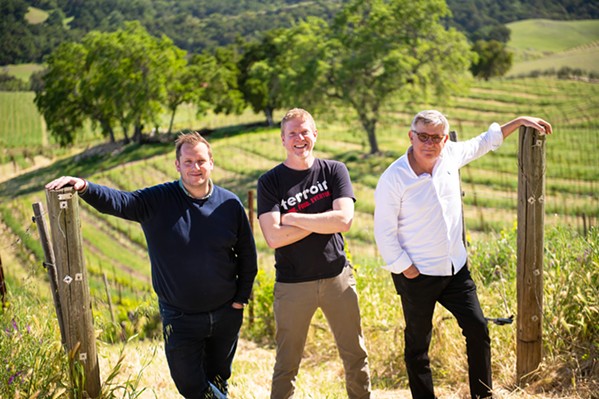 PARTNERS IN WINE Tablas Creek proprietor Jason Haas is flanked by Francois Perrin, right, co-founder of the Paso Robles winery, and Cesar Perrin, Francois' son. The Perrin family's Chateau de Beaucastel in France is Tablas Creek's sister winery. - COURTESY PHOTO BY BRITTANY APP