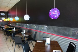 A GREAT PLACE TO PARK:  The new restaurant, complete with truck tire installed in bar and joyful colored lights, reflect Nunes&rsquo; energetic personality and vibrant Asian fusion creations. - PHOTO BY TOM FALCONER