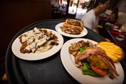 A BURGER OR A BRAT:  Burgers, bratwurst, and schnitzel (breaded and fried tenderized pork loin topped with mushroom Jagr sauce) is served at Wineman - GrillHause at 851 Higuera St. in downtown SLO. - PHOTO BY KAORI FUNAHASHI