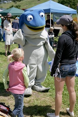 WATCH WHAT YOU PUT DOWN STORM DRAINS, KIDS! :  Sammy the Steelhead Trout greets Earth Day attendees! - PHOTO BY GLEN STARKEY