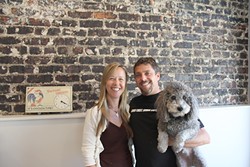 IN THE DOGHOUSE:  Liz and Brian Espy, with Mop the dog, are owners of Doghouse Promotions, a small company specializing in promotional branding that recently relocated to downtown SLO. - PHOTO BY REBECCA LUCAS