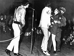 HYSTERIA!:  A girl rushes the stage and grabs The Seeds frontman Sky Saxon at one of their shows. - IMAGE COURTESY OF GNP CRESCENDO RECORDS