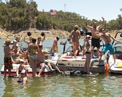 REVELRY ON THE WATER :  Most of the boaters and their friends were happy to show how much fun they were having, as the deputies and the New Times reporters were on the job and thus unable to partake in the festivities. - PHOTO BY STEVE E. MILLER