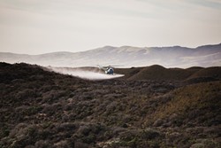 GRASS FIGHT:  A helicopter recently circled above the Guadalupe-Nipomo National Wildlife Refuge, spraying an herbicide being tested to manage veldt grass, an invasive species that threatens to adversely impact the dune scrub habitat. - PHOTO BY KAORI FUNAHASHI