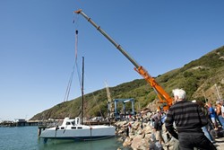 IN SHE GOES :  Nick Del Giorgio&rsquo;s 42-foot, 14-ton catamaran is lifted into the water for the first time. - PHOTOS BY STEVE E. MILLER