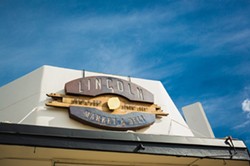 MARKET FRESH:  San Luis Obispo metal wizard Jory Bringham created Lincoln Market&rsquo;s eye-catcing sign as well as the large community table found inside the eclectic hangout, grocery, and deli. - PHOTO BY KAORI FUNAHASHI