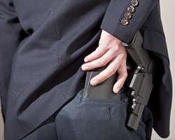 OUT OF SIGHT, ON THE MIND :  More San Luis Obispo County residents have applied for concealed weapons permits in the last two years than in the previous two. - PHOTO ILLUSTRATION BY STEVE E. MILLER