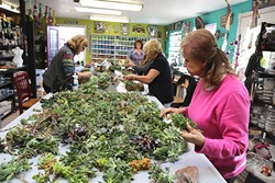 A WEALTH OF SUCCULENTS:  Joan Martin Fee shows Diane Toman, Cindi Karlen, Sandy Ashby, and Lana Hollady how to make succulent wreaths at the Design Studio in Los Osos. - PHOTO BY DYLAN HONEA-BAUMANN