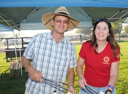TONGS IN HAND :  Bill Sheffer of Halter Ranch Vineyard and Robin Zazueta of Vina Robles dish up some tasty fare, to raise money for the Rotary Club&rsquo;s scholarship fund. - PHOTO COURTESY OF PASO ROBLES ROTARY
