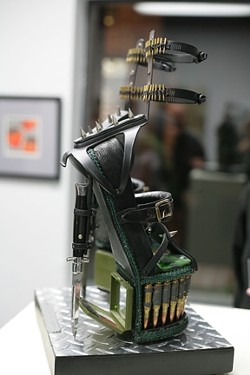 MY FAVORITES! :  While the show is chock full of awesome art, my favorite piece was Larry Le Brane&rsquo;s &ldquo;Combat Stilettos,&rdquo; constructed completely by hand of fused glass, switchblade knives, ammo, hardware, found objects, and &ldquo;G.I. Jane compacts.&rdquo; - PHOTOS BY GLEN STARKEY