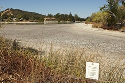 LAKE WOEBEGONE:  Atascadero Lake, a popular destination for tourists and locals alike in wetter times, has been a stinky, expensive headache for the city during this dry, hot summer. - PHOTO BY STEVE E. MILLER