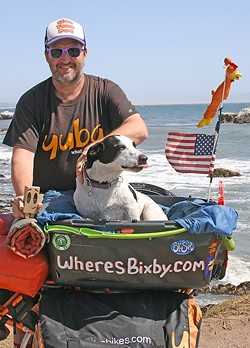 PEDALING FOR PAWS:  Mike Minnick and his shelter dog Bixby were regulars around SLO until late May. The pair has spread their message of rescue dog adoption and is now moving onward across the country. - PHOTO BY HAYLEY THOMAS