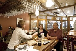 FOR A GOOD TIME :  Rick Cronkhite recently poured some vino for Ralph and Dolores Vasquez at the newly opened Central Coast wines. - PHOTO BY STEVE E. MILLER