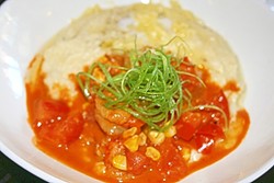 GOT GRITS? :  Shrimp swim in a creamy bowl of hand-milled grits, white cheddar, roasted corn, and tomato. - PHOTO BY HAYLEY THOMAS
