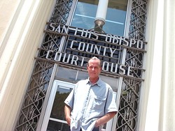Lawrence Bass stands outside the SLO County courthouse, where he has filed restraining orders against a sheriff&rsquo;s deputy and a judge. - PHOTO BY COLIN RIGLEY