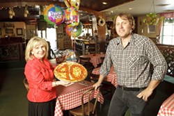 TOP THIS! :  Bernadette &ldquo;Bernie&rdquo; Donakowski&mdash;pictured here with her son Ryan, who manages Del&rsquo;s&mdash;is celebrating 40 years of bringing pizza and other delicious Italian food to the county. - PHOTO BY STEVE E. MILLER