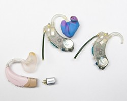 MULTIPLE MODELS:  Hearing aids advance all the time. The latest model is on the left, with older ones on the right. - PHOTO BY STEVE E. MILLER