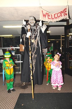 WORLD&rsquo;S TALLEST GREETER!:  In addition to the haunted house, kids can get photos with scary characters and win prizes from carnival games. - PHOTO BY BETTY "DOC" O'CONNOR