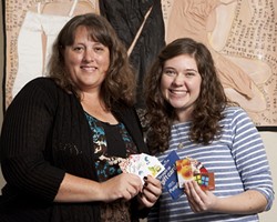 HAPPY HOLIDAYS FOR ALL:  Beth Raub and Anna Clauson (Directors of Volunteers and Outreach) showcase giftcards that have been purchased with donated money for the Women&rsquo;s Shelter of San Luis Obispo. - PHOTO BY STEVE E. MILLER