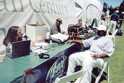 IN THE FIELD:  CJ Silas interviews sports reporter Ahmad Rashad in 2004. While the men she worked with tended to make work miserable, she writes, listeners appreciated her unique take on sports talk. - PHOTO COURTESY OF CJ SILAS