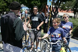 BLESSED! :  The Jiminez family&mdash;(left to right) Mario, Sevryn, and Sherry&mdash;collectively get their bikes blessed. Sherry owns Salon 544 and organized the free family event. - PHOTO BY GLEN STARKEY
