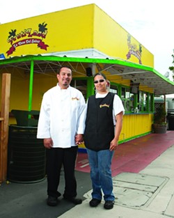 FAMILY FOOD:  Jose and Grissel Rojas, owners of Frutiland&mdash;La Casa Del Sabor, stand proudly in front of their small restaurant where they make food with big flavors. - PHOTO BY STEVE E. MILLER