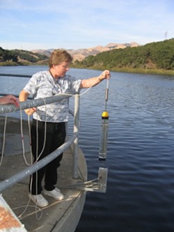 TESTING THE WATERS :  Lopez Lake water spends 30 days in the terminal reservoir off Orcutt Road, where Water Systems Chemist Lisa Wallender grabs samples at various depths. - PHOTO BY KATHY JOHNSTON