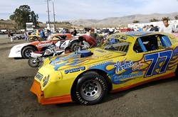 JUMP IN THE PIT:  The pit at the Santa Maria Speedway sits in the middle of the oval track. Before each heat and race, cars are tuned, wiped clean, and tinkered with until they are ready for the next event. - PHIL KLEIN