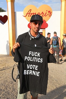 TRANSFORMATIONAL POLITICS:  Lightning in a Bottle co-founder Dede Flemming holds up a shirt supporting Bernie Sanders. - PHOTO BY DYLAN HONEA-BAUMANN