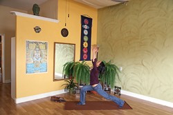 LET IT FLOW:  Silvia Suarez, new owner of the Holistic Movement Center in Morro Bay, demonstrates the warrior one yoga posture. Silvia won the studio through a contest and officially took over in January. - PHOTO BY DYLAN HONEA-BAUMANN