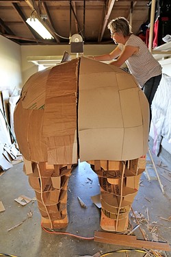 BIG, BEAUTIFUL RHINOCEROS :  Abby Belknap, an artist in the Central Coast Sculptors Group, works on the sizeable rear end of the rhinoceros. - PHOTO BY DYLAN HONEA-BAUMANN